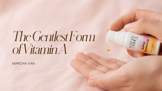 Witchy Lashes Retinyl Renewal Oil bottle dispensing a drop of oil into a cupped hand on pink fabric