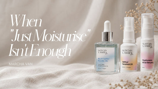 Three Witchy Lashes Skin products — Blue Tansy Facial Oil, Retinyl Renewal Oil and Hyaluronic Acid Serum — arranged on beige linen with dried flowers